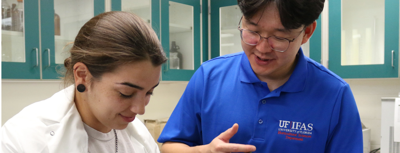 Dr. Seunghyun Choi instructs a student in his plant propagation lab.